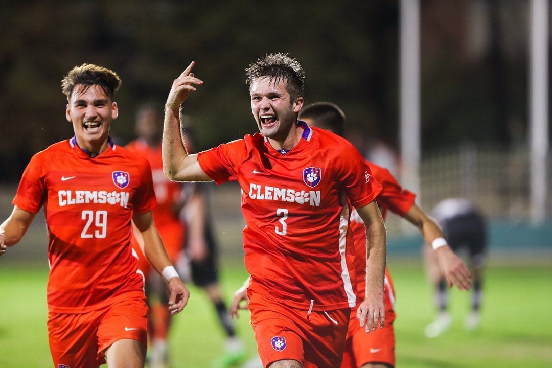 Adam Lundegard celebrating in Clemson kit alongside a teammate